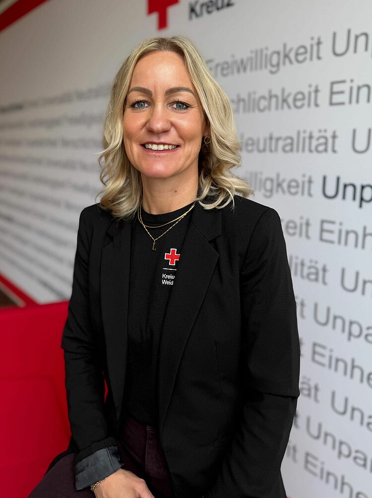 Portrait_Merdan_Katrin Zeigt Mitarbeitenden mit BRK Oberteil